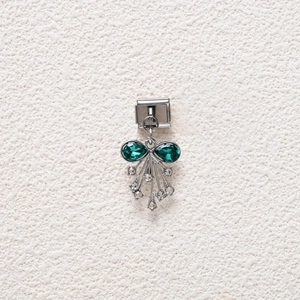 Detail of Italian charm link featuring green pear gems and white zircon tassels