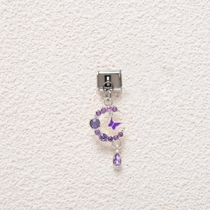 Detail of moon charm with purple crystals and butterfly enamel for modular bracelet