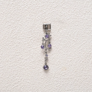 Macro detail of silver stainless steel charm link with elegant purple gemstone pendant