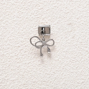 Detailed view of a silver bow charm pendant for modular DIY jewelry making