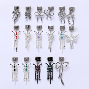 Macro shot of various modular Italian charms featuring bows and colorful gemstones