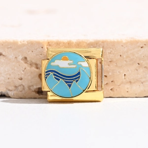 Detail of Italian charm link featuring gold plating and enamel beach landscape art
