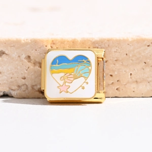 Detail of Italian charm link featuring gold heart with beach landscape and starfish