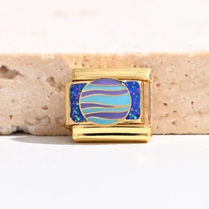 Macro shot of gold Italian charm link featuring planet design and starry blue enamel