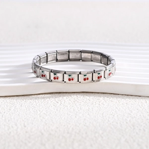 Detailed macro view of cherry charm link on a polished stainless steel Italian bracelet