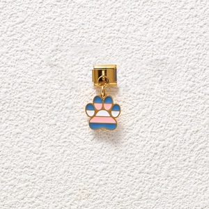 Close-up of golden Italian charm with colorful striped paw print dangle detail