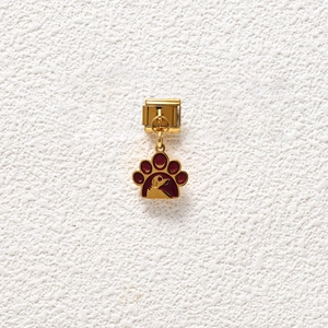 Detailed view of a gold modular bracelet link featuring a maroon paw print pendant