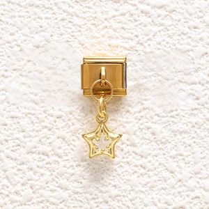 Detailed close-up of a golden Italian charm link featuring a sparkling star pendant