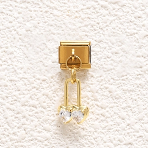 Detail of gold Italian charm with dangling double heart cubic zirconia on steel base