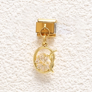 Detail of Italian gold charm with cubic zirconia inlay for DIY modular bracelets