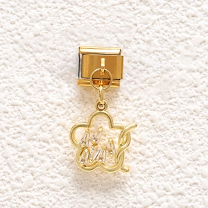 Macro shot of gold-plated five-petal flower charm link with cubic zirconia for bracelets