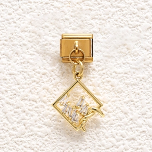 Detail of gold modular bracelet charm with square frame and baguette-cut zircons