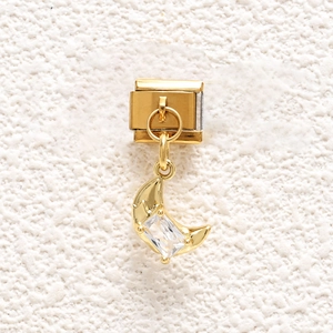 Macro detail of golden crescent moon charm link with rectangular zircon for Italian bracelet