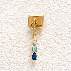 Detail of Italian charm link in gold stainless steel with blue zircon drop pendants