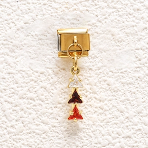Close-up of golden Italian charm link with three-color triangular zircon gemstones