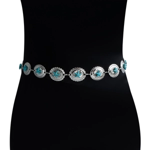 Detail of bohemian silver waist chain featuring turquoise starfish accents on a mannequin
