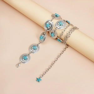 Detail of bohemian waist chain featuring turquoise starfish accents on silver metal discs
