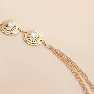 Detail of golden waist chain with heart pearls and textured round metallic plates