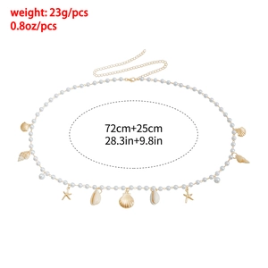Detail of pearl body chain with golden starfish charms and shell pendants for summer