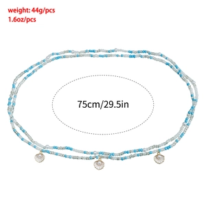 Detail view of double-layer beaded waist chain with shell charms and pearls, 75cm length