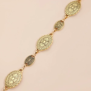 Detailed view of vintage gold waist chain with intricate sunburst and scroll engravings