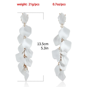 Dettaglio di lunghi orecchini a petalo bianco con lunghezza 13,5 cm e peso di 21 g