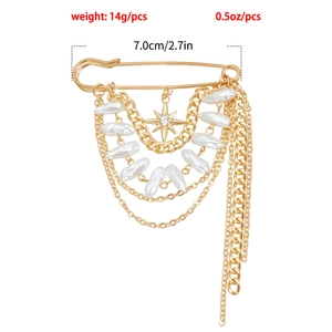 Close-up of vintage gold tassel brooch with multi-layer chains, faux pearls and star charm