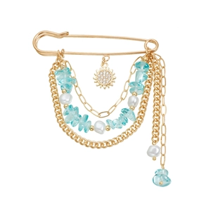Broche épingle dorée avec pendentif soleil, pierres bleues et chaînes de perles