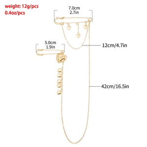 Detailed view of vintage gold heart brooch showing dimensions and dual safety pin chains