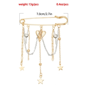 Detail of layered gold brooch with star and heart pendants showing dimensions and 13g weight