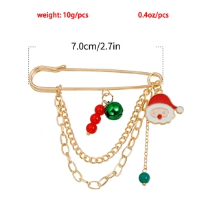 Detail view of gold Christmas brooch with Santa enamel, bells, beads and layered chains