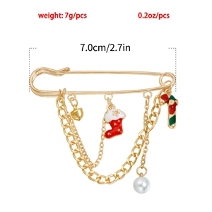 Detailed view of Christmas safety pin brooch with festive charms and 7cm size marking