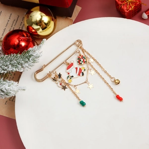 Detail of Christmas brooch featuring Santa Claus, snowman, and gold bell charms