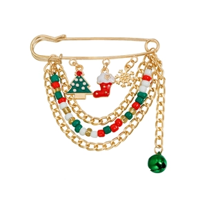 Detailed close-up of Christmas brooch with multi-layer gold chains and festive charms