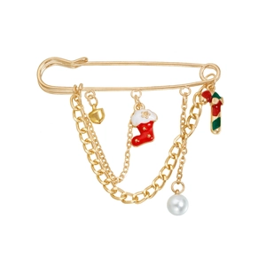 Detail of Christmas gold brooch with red socks, candy cane, heart, and pearl charms