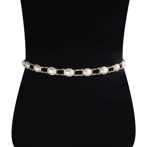 Detail view of oval pearls set in gold metal chain links on a stylish waist belt
