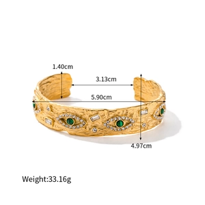 Golden evil eye textured open bangle with green malachite stones and white crystal accents