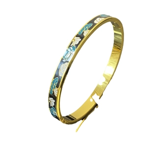 Brazalete vintage de acero de titanio dorado con ondas de esmalte azul blanco y negro