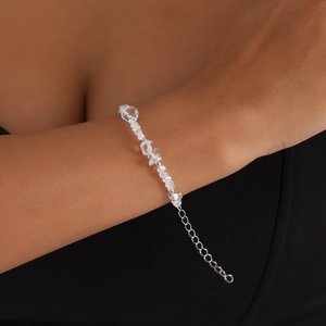 Detail of clear irregular crystal stone bracelet with silver beads on a model wrist