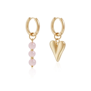 Detail of asymmetrical gold earrings featuring pink beads and a 3D heart pendant