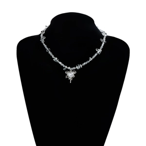 Detail of hollow heart pendant on irregular white stone beads necklace for women