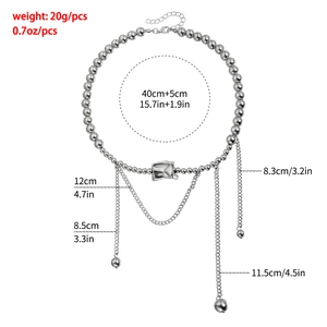 Detailed view of silver beaded necklace with wavy metal pendant and tassels showing weight 20g
