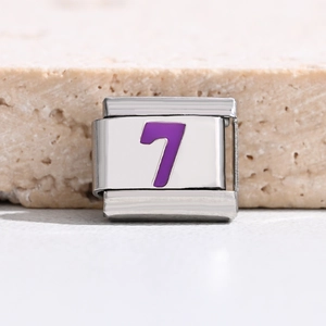 Macro detail of Italian charm bracelet link with purple number 7 on stainless steel base