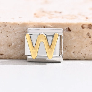 Macro shot of gold letter W charm link for Italian modular stainless steel bracelet