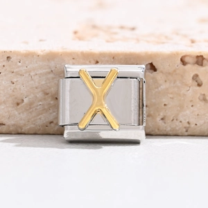 Close-up of a stainless steel Italian charm bracelet link with a golden letter X