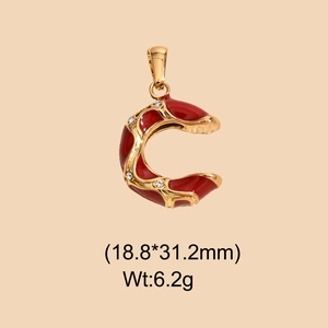 Detail of red enamel letter C pendant with gold plating and white crystal accents