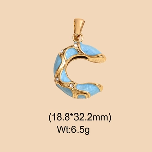 Detail view of a gold-plated letter C pendant with blue enamel and zircon stones, 18.8x32.2mm