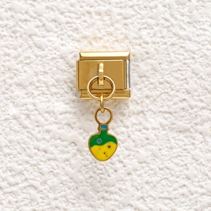 Italian charm link with gold-plated heart-shaped potion bottle on white texture