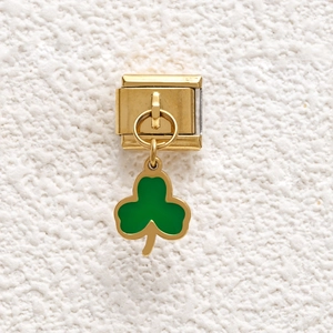 Detail of Italian modular bracelet link with a golden green enamel shamrock pendant