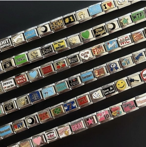 Makroaufnahme silberner Edelstahl-Charm-Armbänder mit bunten Emaille-Symbolen im Set